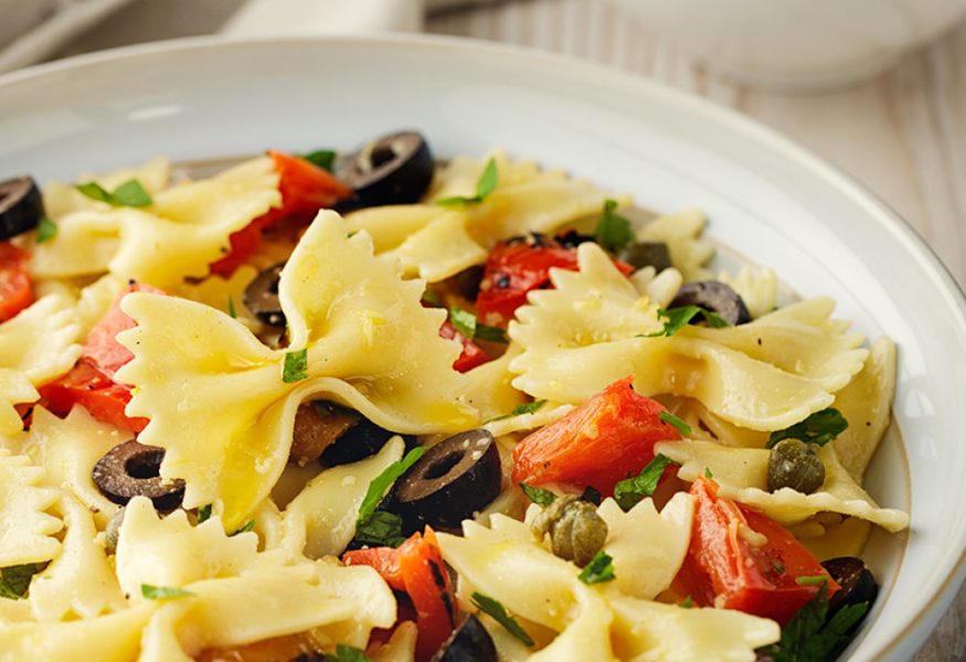 Farfalle pasta with marinated anchovies and black olives